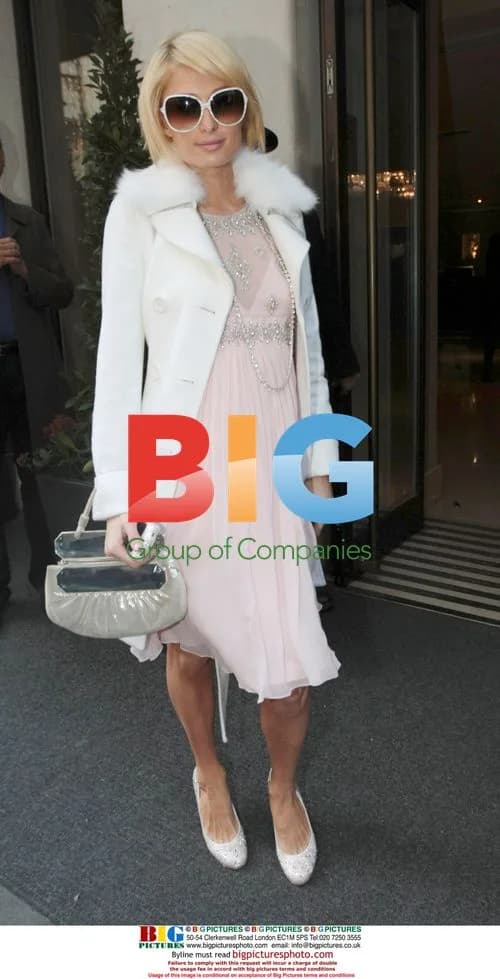 Paris Hilton leaves hotel in pink taxis