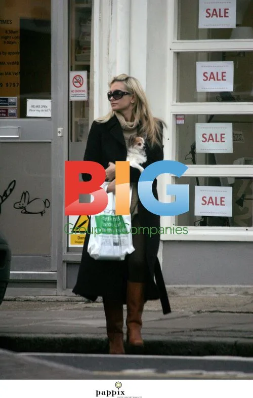 Caprice Bourret picks up dog from vet