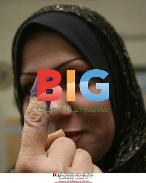 Iraqi voter shows ink-stained finger after voting