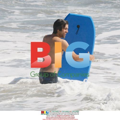 Adrien Grenier body-boarding in Malibu