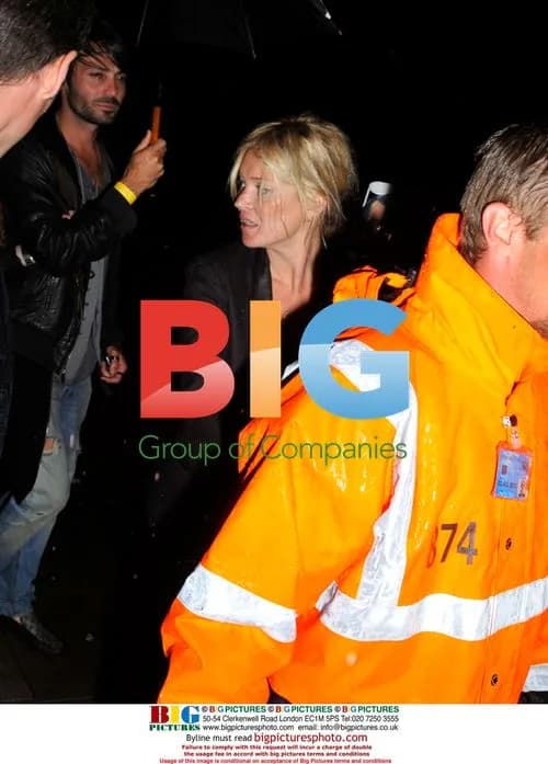 Kate Moss has trouble with shoes at Lily Allen gig