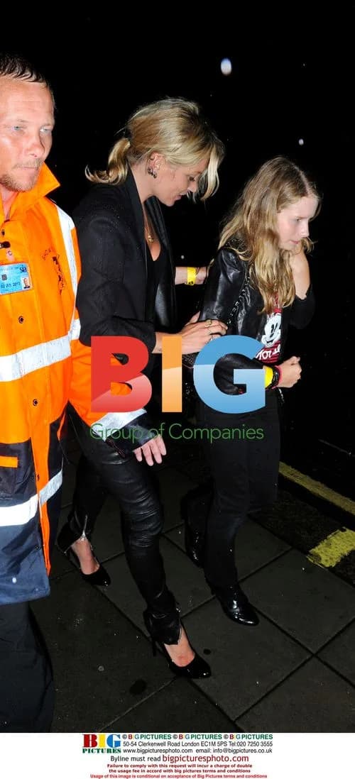 Kate Moss struggles with shoes at Lily Allen gig