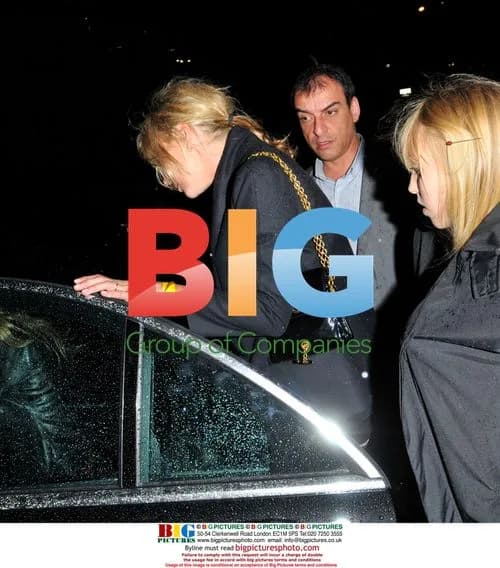 Kate Moss struggles with shoes at Lily Allen gig