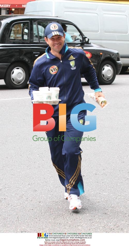 Ricky Ponting runs across road with coffee