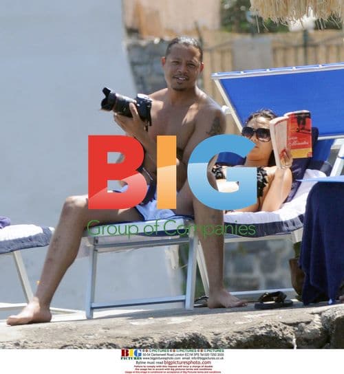 Terence Howard relaxes on the beach with family