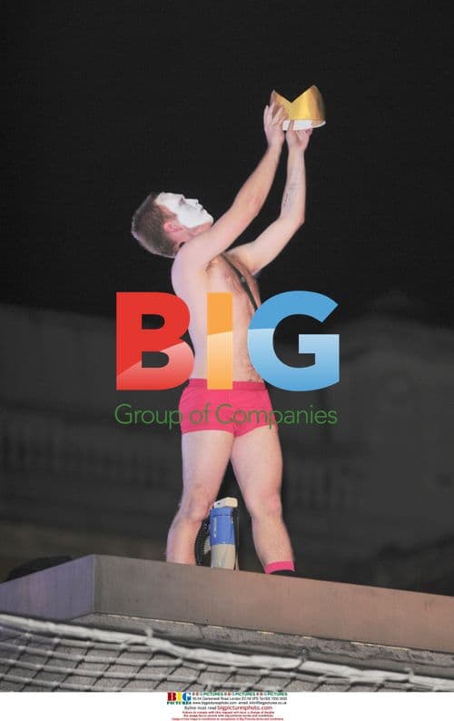 Performer strips on Trafalgar Square pedestal