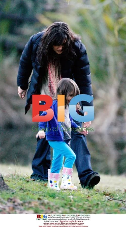 Katie Holmes and Suri playing in leaves on set