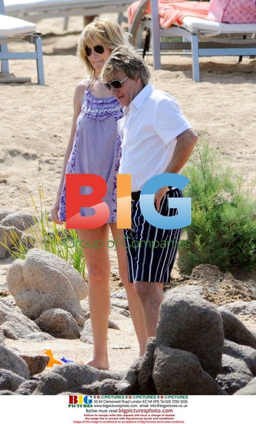 Rod Stewart and Penny Lancaster on beach in Italy