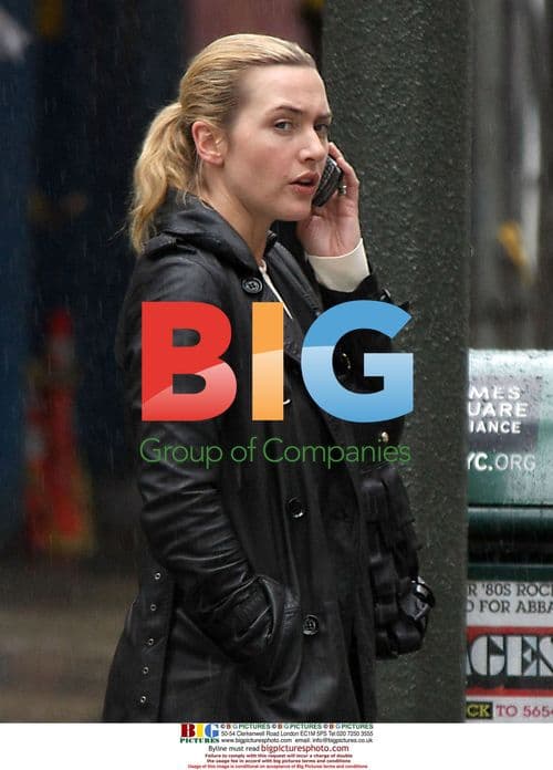 Kate Winslet talking on phone in rain
