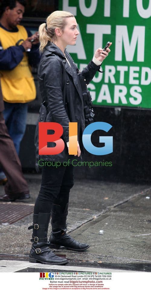 Kate Winslet chatting on phone in the rain