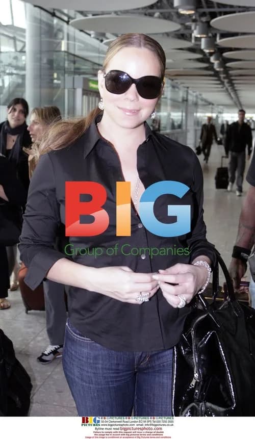 Mariah Carey arrives in London with many bags