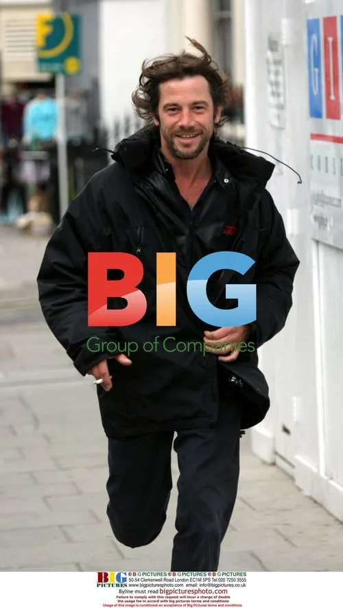 Jay Kay hurried jog with cigarette in London