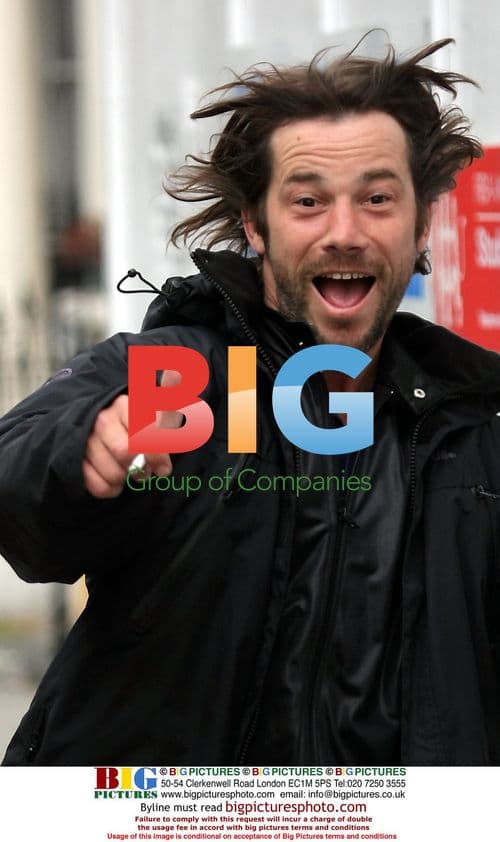 Jay Kay jogging with a cigarette in London