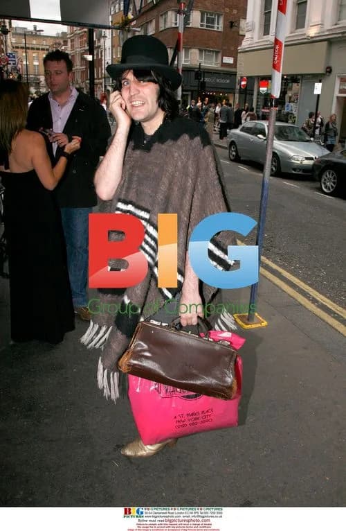 Noel Fielding chats on phone outside Groucho's