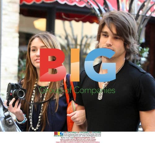 Miley Cyrus and Justin Gaston at the Grove