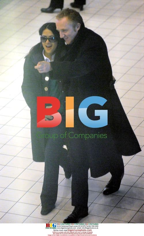 Pinault and Hayek share affectionate moment at Paris airport