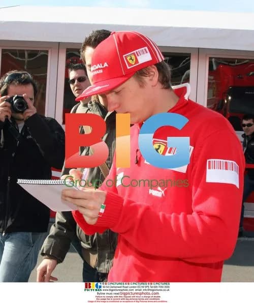 Schumacher and Raikkonen sign autographs
