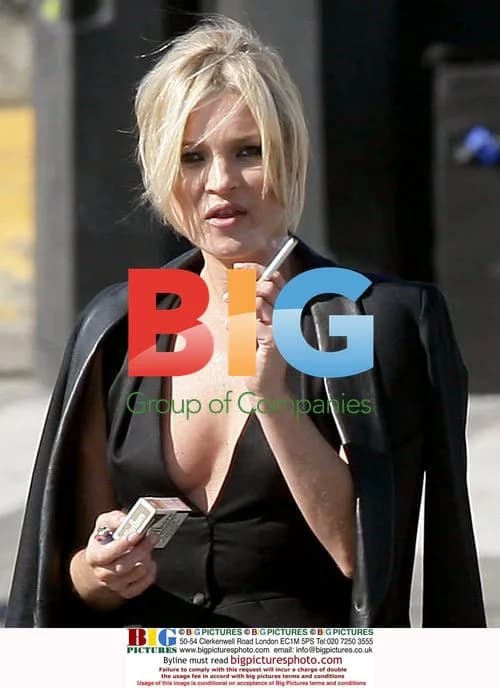 Kate Moss takes a cigarette break in Paris