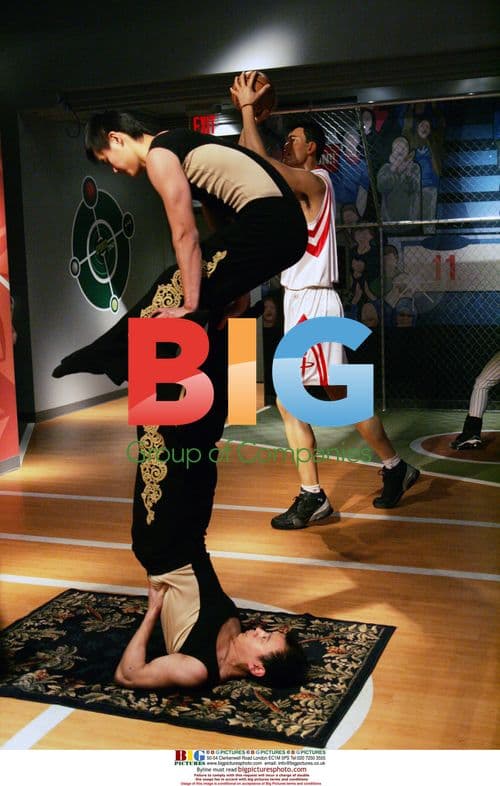 Chinese acrobats perform with Yao Ming wax figure