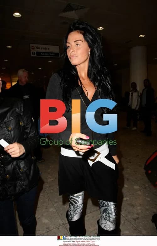 Katie Price arrives at Heathrow with balloons