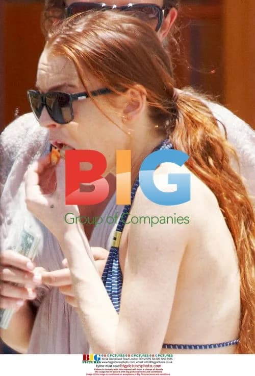 Lindsay Lohan relaxes by pool in Maui