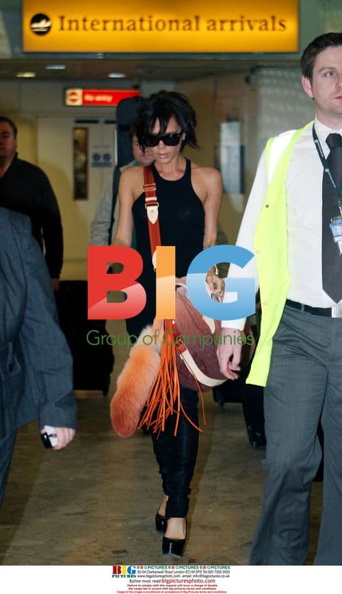 Victoria 'Posh' Beckham Arrives at Heathrow