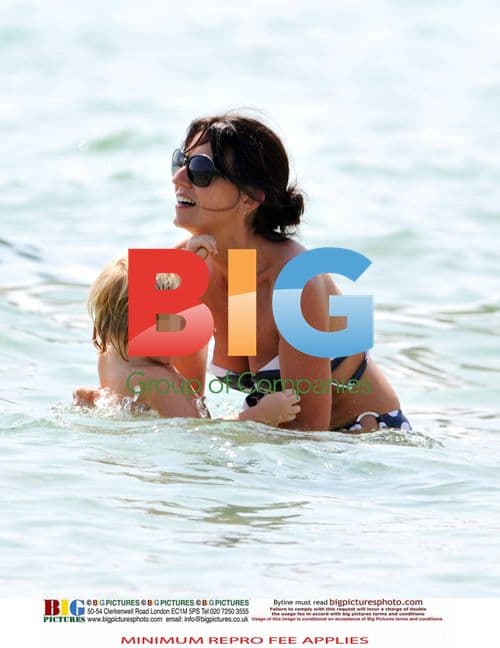 Davina McCall enjoys family beach vacation