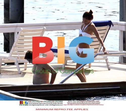 Singer Bryan Ferry and girlfriend relax on vacation