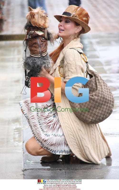 Pheobe Price kisses dog Henry in rain
