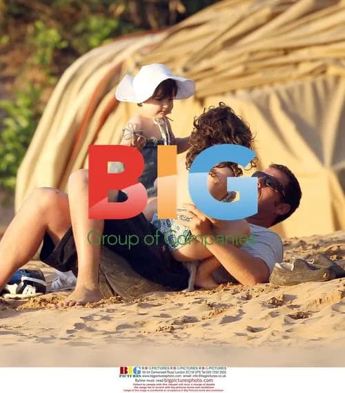 Adam Sandler with children on beach
