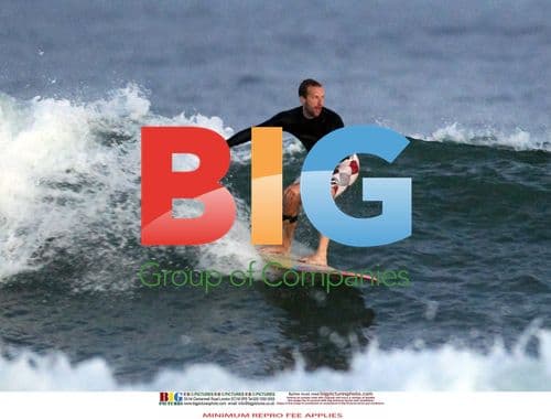 Chris Martin surfing in the Hamptons
