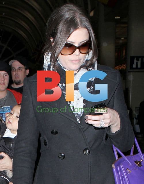 Kardashian sisters return to LAX with baby Mason