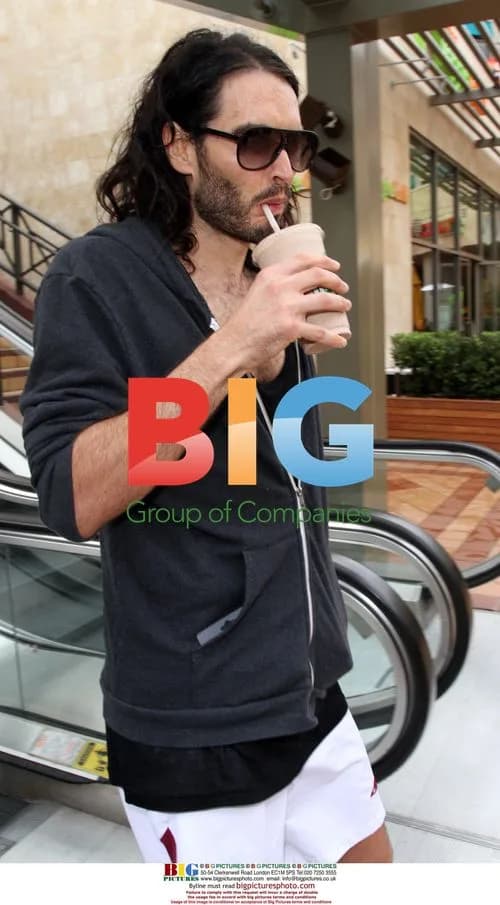 Russell Brand visits gym in West Ham socks