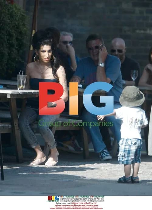 Amy Winehouse Interacts with Child at Pub