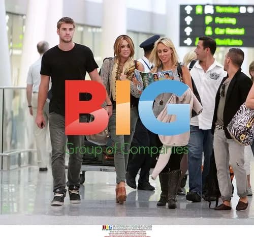 Miley Cyrus Arrives at Airport with Mom and Boyfriend