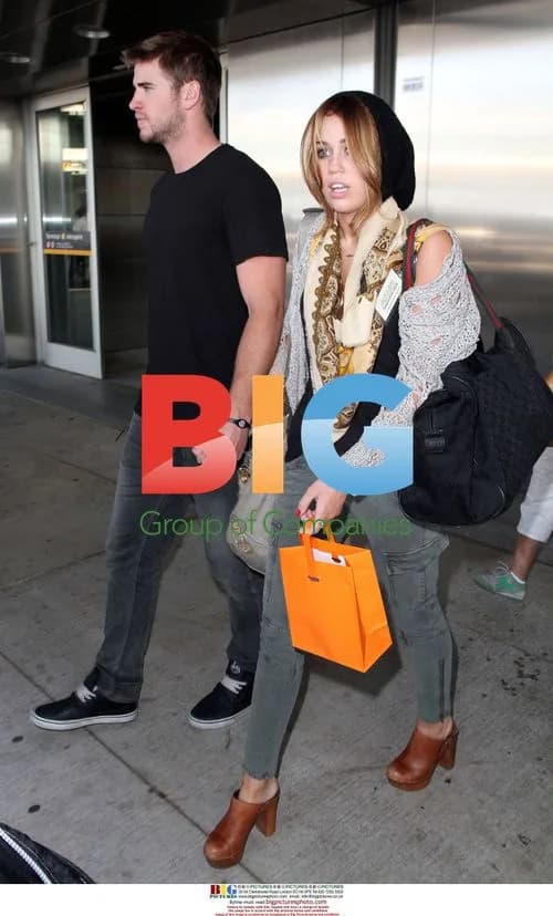 Miley Cyrus Arrives at Airport with Mom and Boyfriend