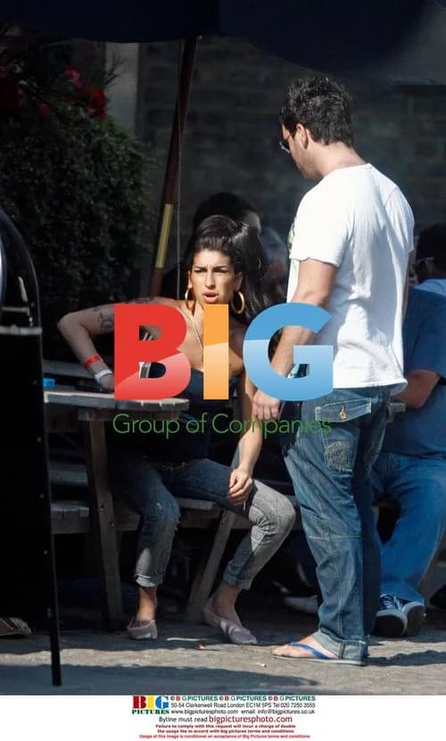 Amy Winehouse Interacts with Child at Pub