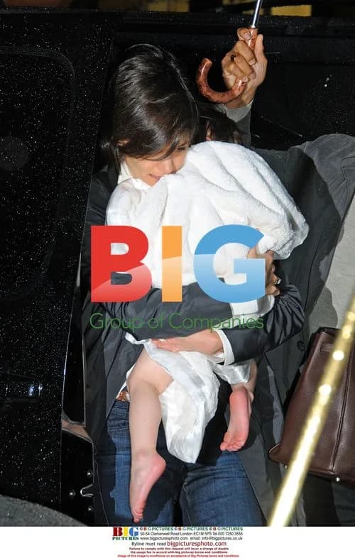 Katie Holmes carries daughter Suri in NYC